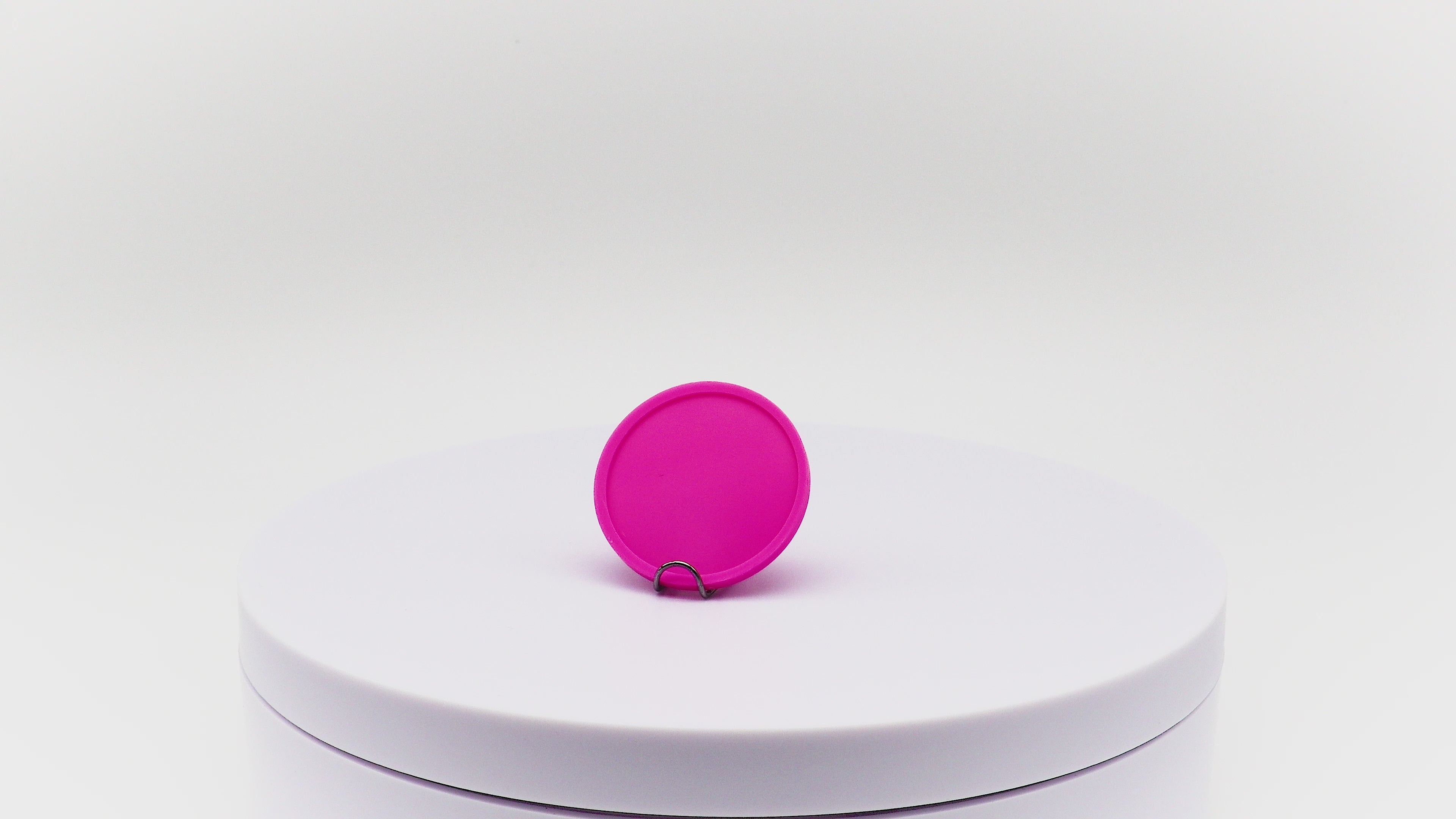 Video of dark pink reward token rotating