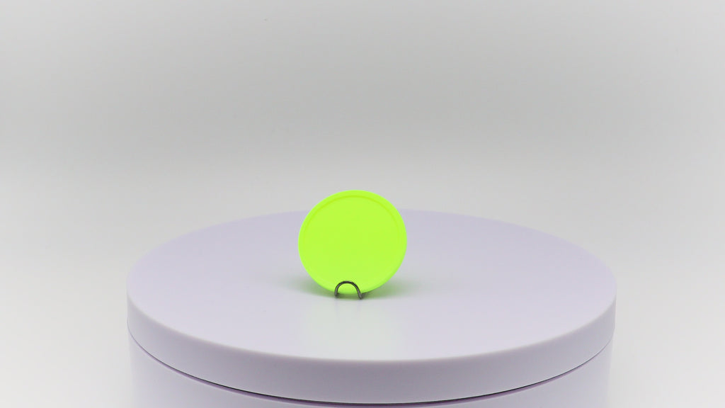 Video of neon yellow event token rotating